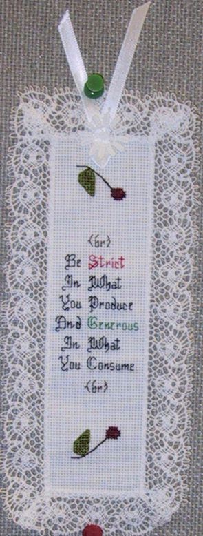 Needlepoint bookmark, reading: Be strict in what you produce and generous in what you consume.
